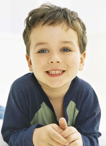 portrait of a boy lying down and smiling